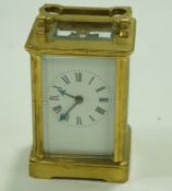 A carriage clock in brass case, striking on a gong,