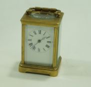 A French carriage clock in brass case, striking on a gong, stamped France, 16.