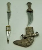 An 20th century Omani dagger heavly decorated with white metal 31cm,