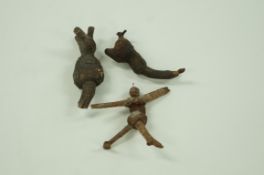 Three West Country wooden mobiles, one in the form of a figure with a walnut head,