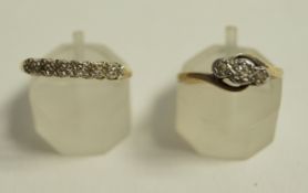 A three stone diamond ring, stamped '9ct', the single cuts illusion set,