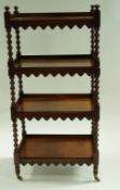An early Victorian four tier what not with turned uprights on brass and ceramic casters.