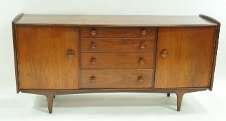 A Hunters of Derby rosewood mid 20th century sideboard with four drawers flanked by two cupboard