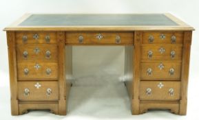 An oak Gothic revival style kneehole partners desk,