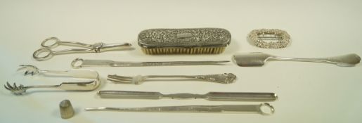 A collection of silver plated items including a cheese scoop; meat skewers;