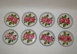 A set of eight Wemyss pottery bowls each painted with two roses with green line rims,