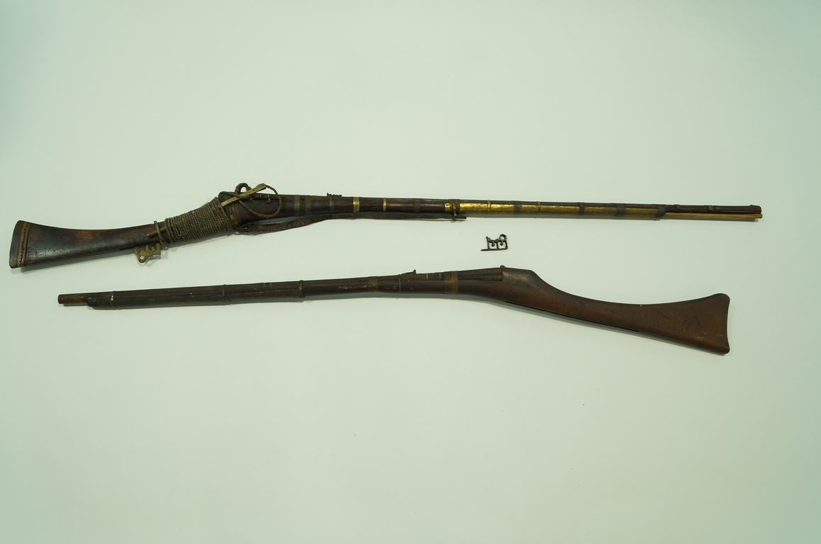 A pair of 19th century Middle Eastern guns, with brass and steel mounts,