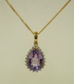 A 9ct gold QVC pendant, the amethyst enclosed by single cut diamonds, on a 9 carat gold chain,