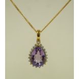 A 9ct gold QVC pendant, the amethyst enclosed by single cut diamonds, on a 9 carat gold chain,