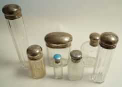 A collection of seven silver topped toilet bottles,