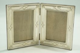 A silver double photograph frame, by R.