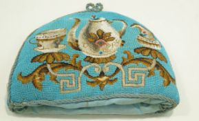 A Victorian beaded tea cosy decorated with a coffee pot, a milk jug, and a teacup and saucer,