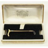 A two colour brooch, in the form of a riding crop, stamped 'J.G. & S 9ct', 5.8 cm long, 4.