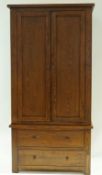 An oak wardrobe with two panelled dors above two drawers, 131cm high, 91cm wide, 54.