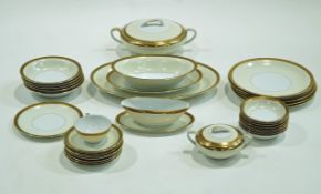 A Noritake part dinner service with gilt flower band above a wide pale yellow band,