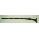 A 19th century precussion rifle with white metal mounts and an ivory and wooden stock,