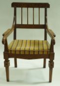 An Arts and Crafts style ash elbow chair with drop in seat and square tapering legs