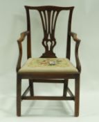 A 19th century mahogany elbow chair with drop in tapestry seat on square legs