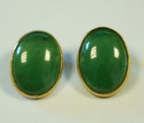 A pair of nephrite clip earrings, stamped '14K', the oval cabochons 2 cm long, 9.