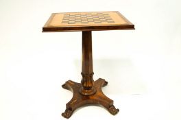 A walnut Chess table with leather inset top with carved octagonal pedestal shaped base on four