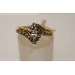 A diamond cluster ring, stamped '14K',