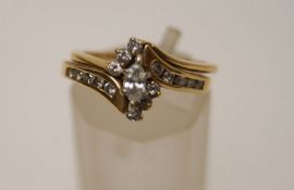 A diamond cluster ring, stamped '14K',