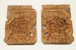 Two 20th Century Chinese carved elm panels, each with typical scenes of dragons,