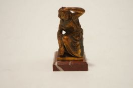 An early 20th Century bronze model of a lady carrying wheat sheaves,