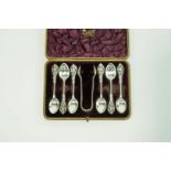 A cased set of six late Victorian silver tea spoons and sugar nips, by William Comyns, London 1892,