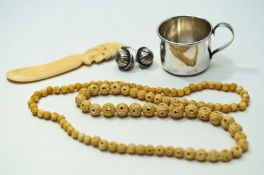An American silver can shaped small mug; a string of beads;
