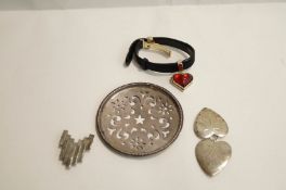 A Lalique leather strap bracelet with a glass mounted heart locket attached;