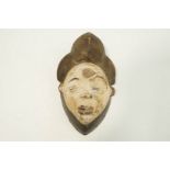 A carved Puno face mask,