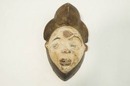 A carved Puno face mask,