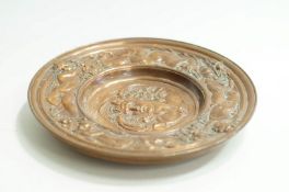 An early 20th Century Copper bowl base, base embossed with a female head surrounded by Cherubs,