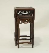 A nest of two Chinese rosewood tables, each with a pierced frieze, 53.5cm high, 27.5cm wide, 27.