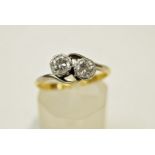 A two stone diamond crossover ring, stamped '18ct',