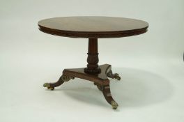 A good William IV mahogany breakfast table, the tilt top on carved needed pedestal on triform base,
