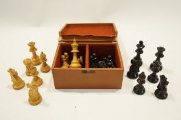 An early 20th Century wooden chess set in a leather box.