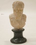 A carved alabaster bust of a gentleman on a 19th Century green marble socle, possibly Roman,
