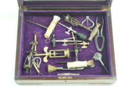 A collection of corkscrews in lockable display cabinet, including bone handle, peg & worm,