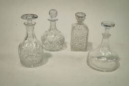 Three cut glass decanters together with a ships decanter.