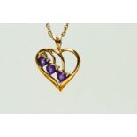 A 9ct gold three stone amethyst heart shaped pendant, on a chain, 3 g gross,