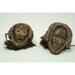 A pair of Chokwe ceremonial masks with Cownie masks & feathers,