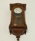 A Vienna Regulator in walnut case with enamelled dial. 70.