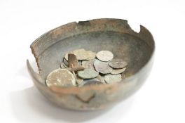 A Roman bronze bowl, along with a small collection of 20mm and later coins.
