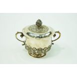 A silver two handled caudle cup and cover, makers mark overstruck, London 1908,