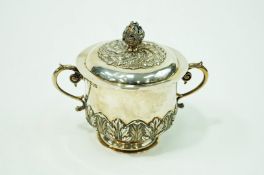 A silver two handled caudle cup and cover, makers mark overstruck, London 1908,