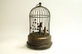 A musical bird automation, with two birds in a metal cage,