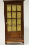 A French mahogany standing cupboard with panelled bevelled glazed doors on turned legs. 149.
