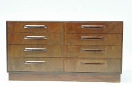 A G plan style chest of eight drawers on a plinth base,